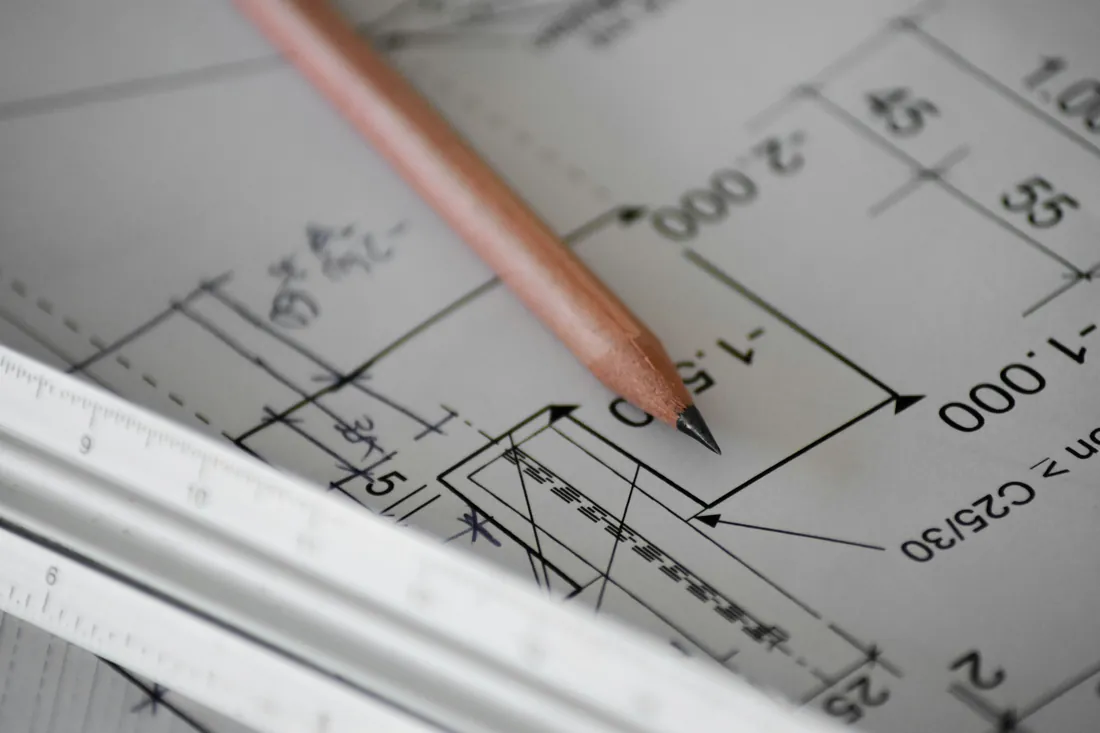Pencil on an engineering drawing with dimensions